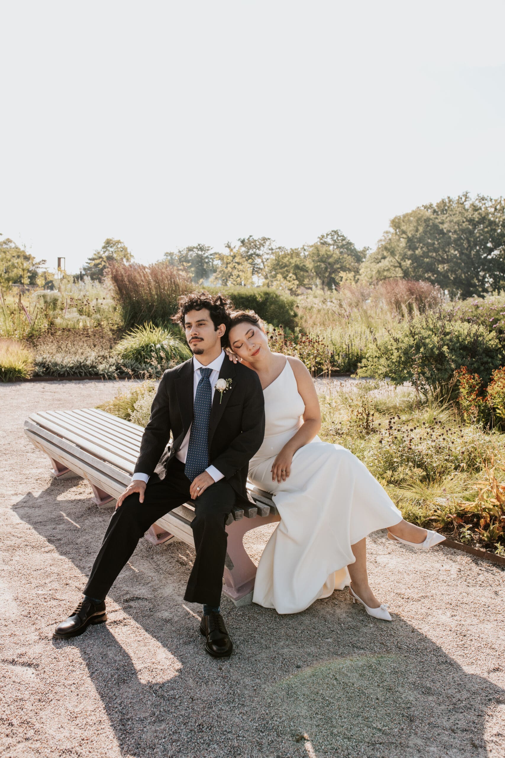 bride and groom sit peacefully at belle isle park in Detroit