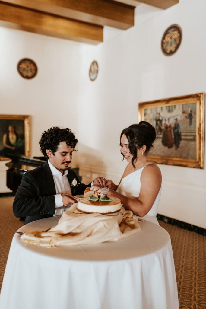 bride and groom cut their cake at their reception a the Detroit Yacht Club Ballroom