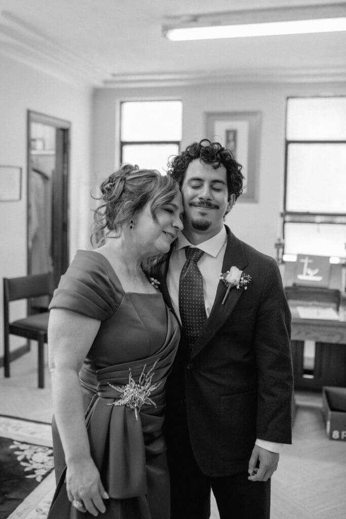 Groom and his mother hugging before the ceremony at Gesu Catholic Church in Detroit Michigan