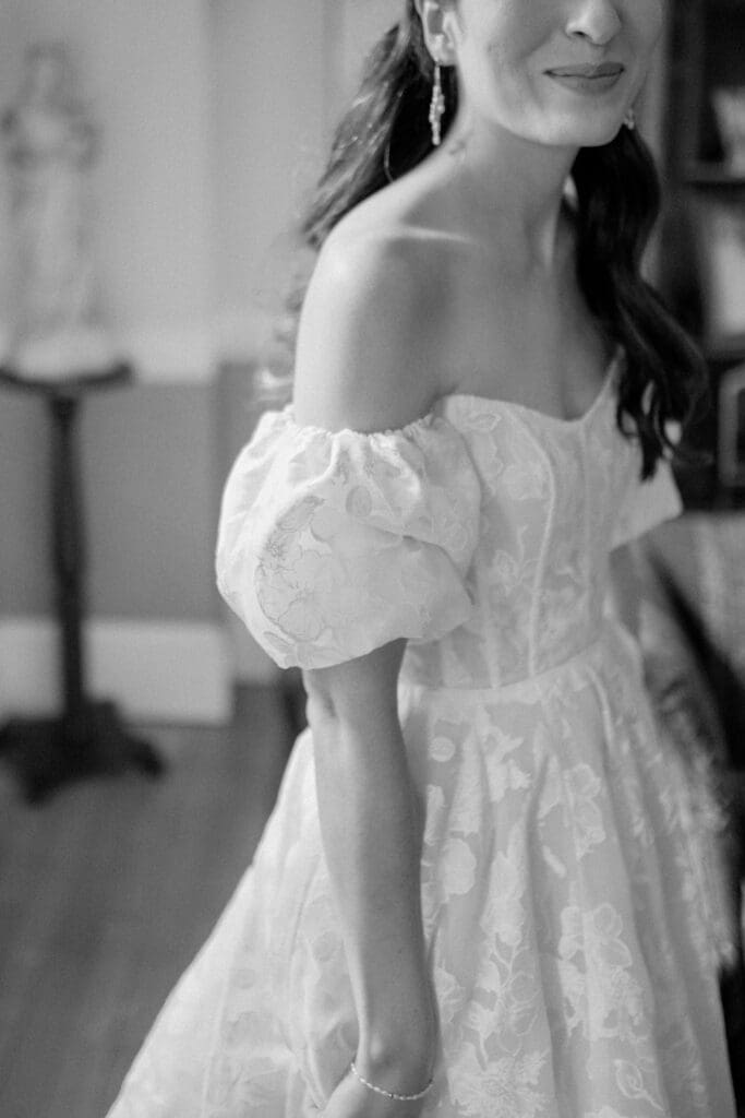 a detail shot of the bride's shoulder with a puffy sleeved off the shoulder dress