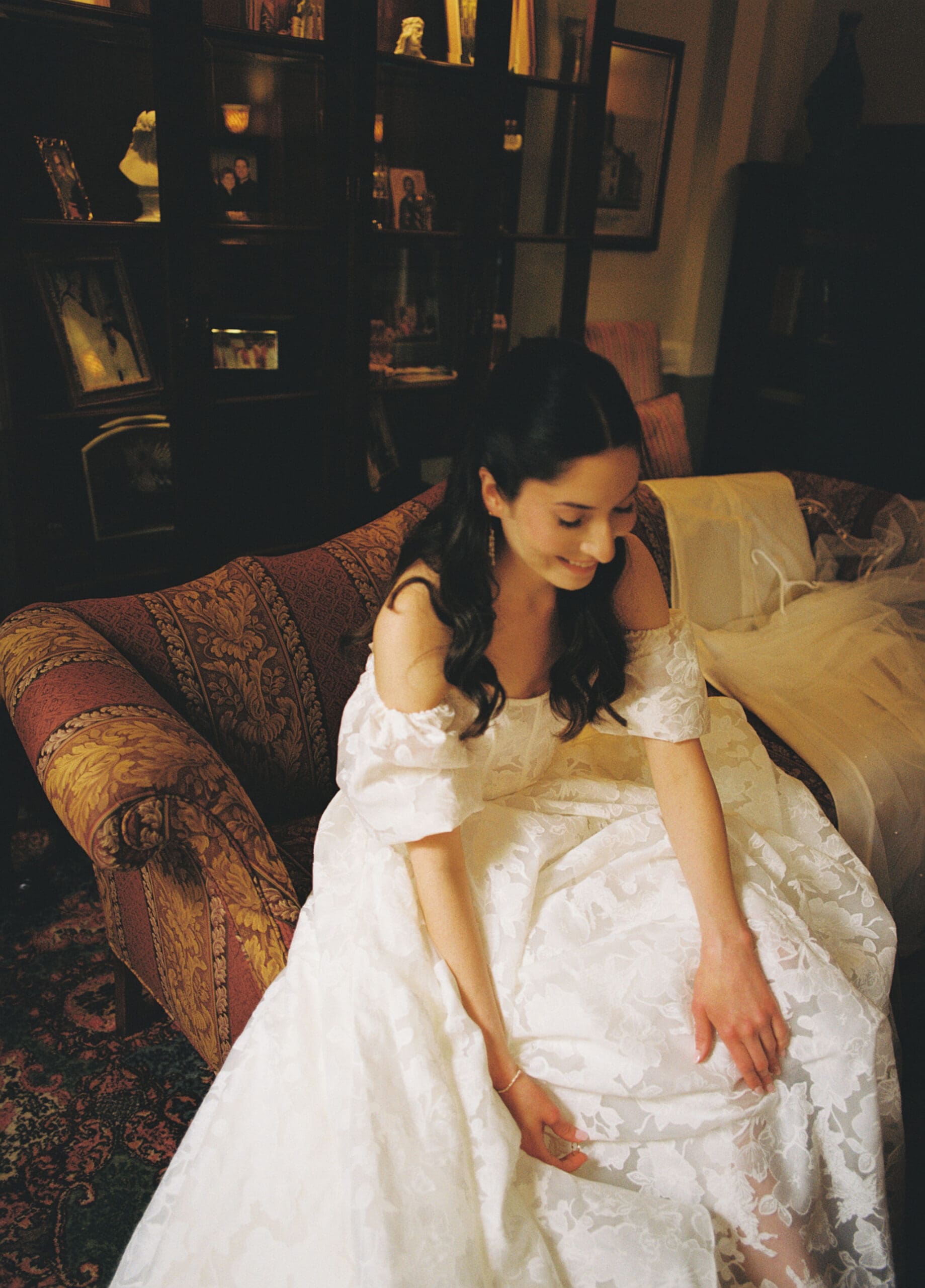 medium format film photo of the bride putting on her shoes while getting ready before her St. Mary of the Assumption Parish wedding