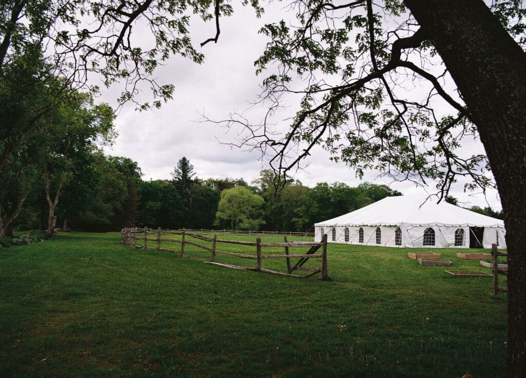 Boston spring time outdoor wedding reception tent in a field shot on film