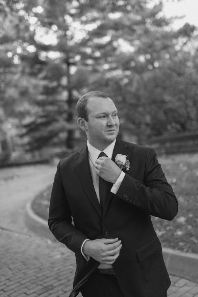 Groom portrait on 4th Street brick road with fall leaves in Atchison KS