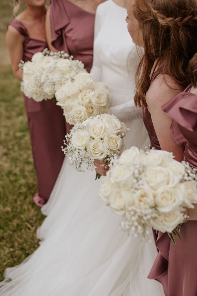 Bridesmaids and their bouquets at the atchison golf club