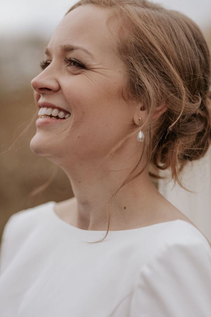 close up of a bride smiling on her wedding day on a fall afternoon