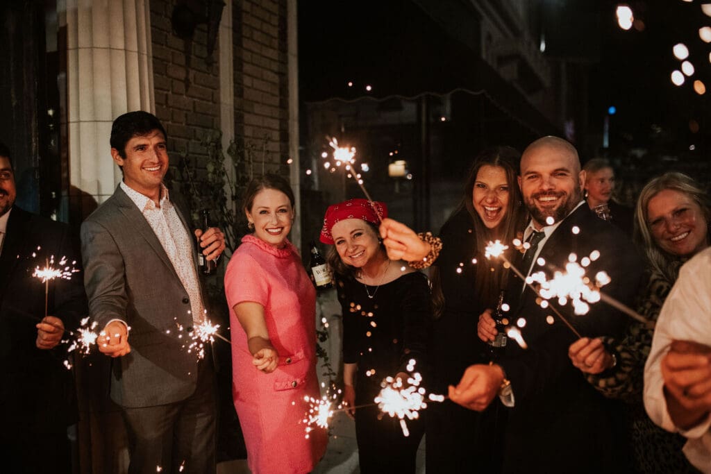guests hold sparklers for sparkler exit at the end of the night for a wedding reception