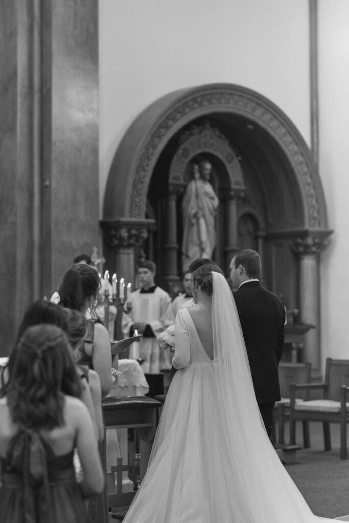 Couple standing at the altar during St. Benedict’s Parish wedding ceremony