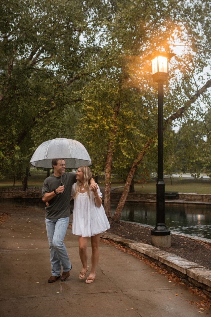 boy and girl walking with an umbrella on a rainy day
