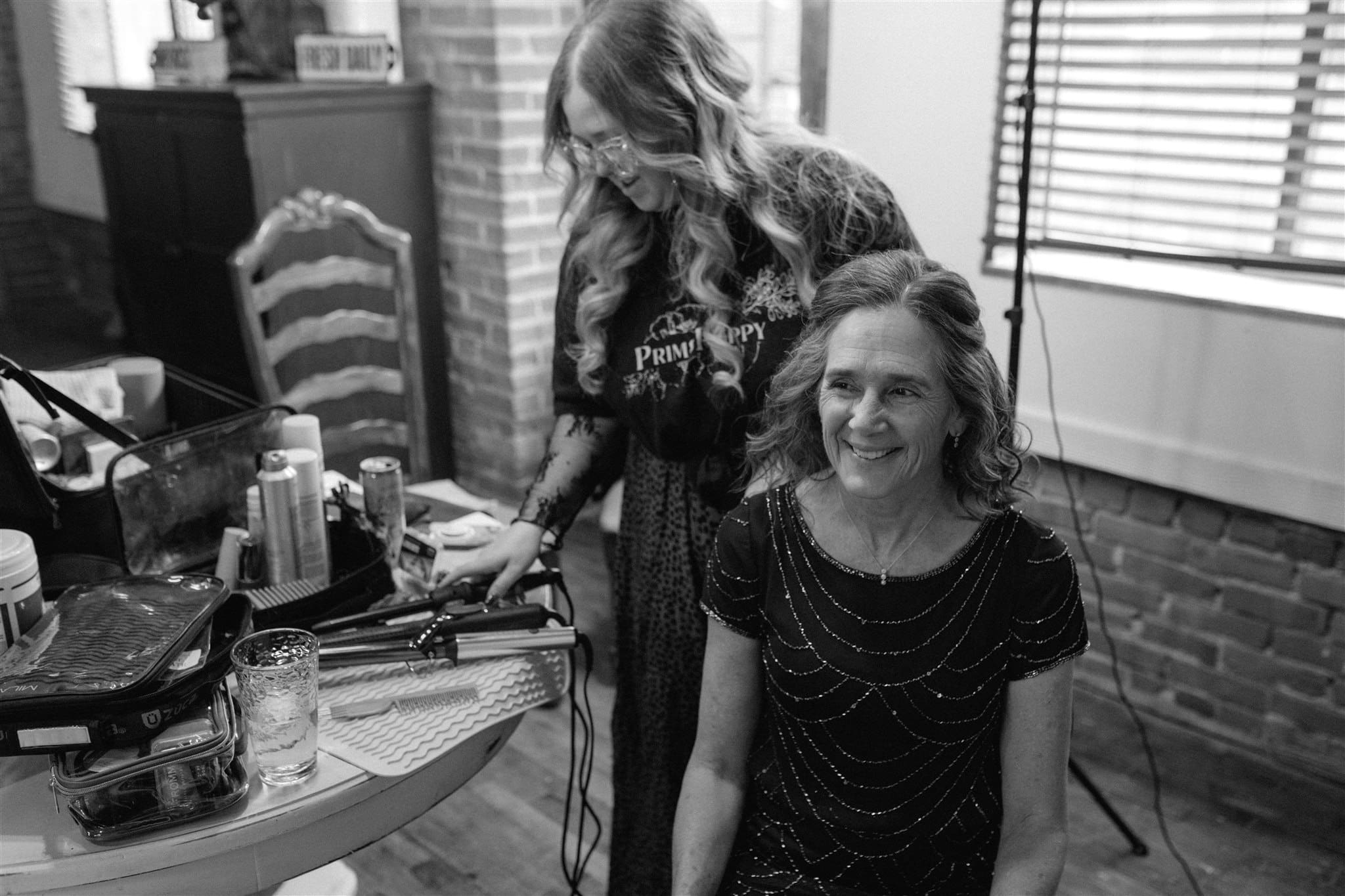 Bailey Rose Makeup Artistry styling hair for mother of the bride during wedding morning getting ready