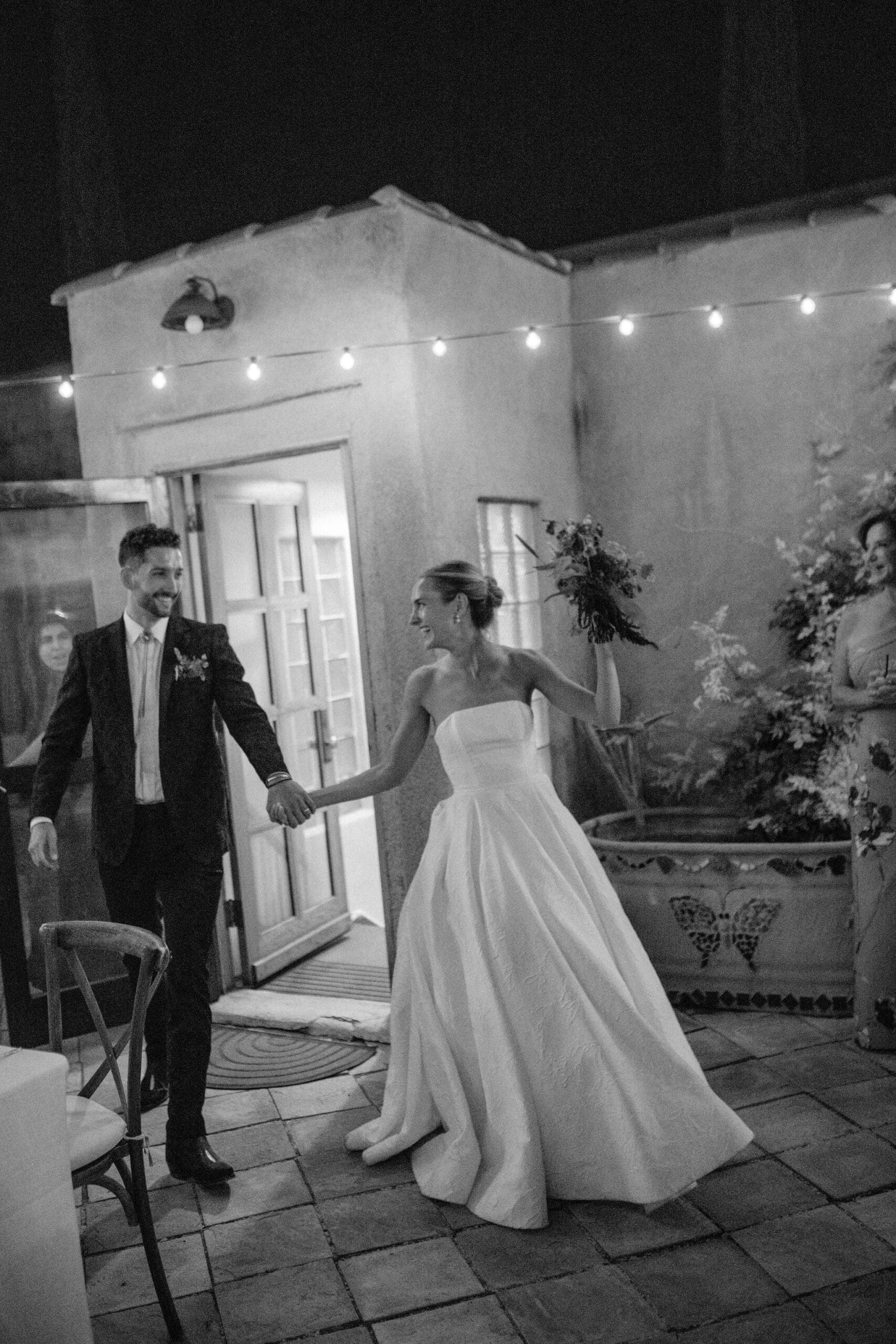 Bride and groom grand entrance into wedding reception courtyard