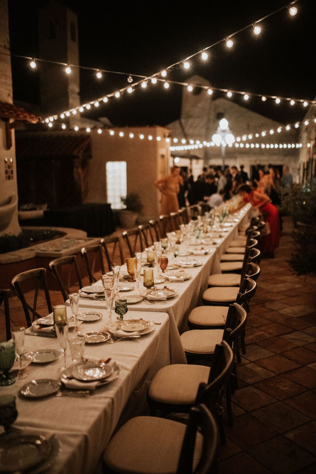 Long reception table under string lights