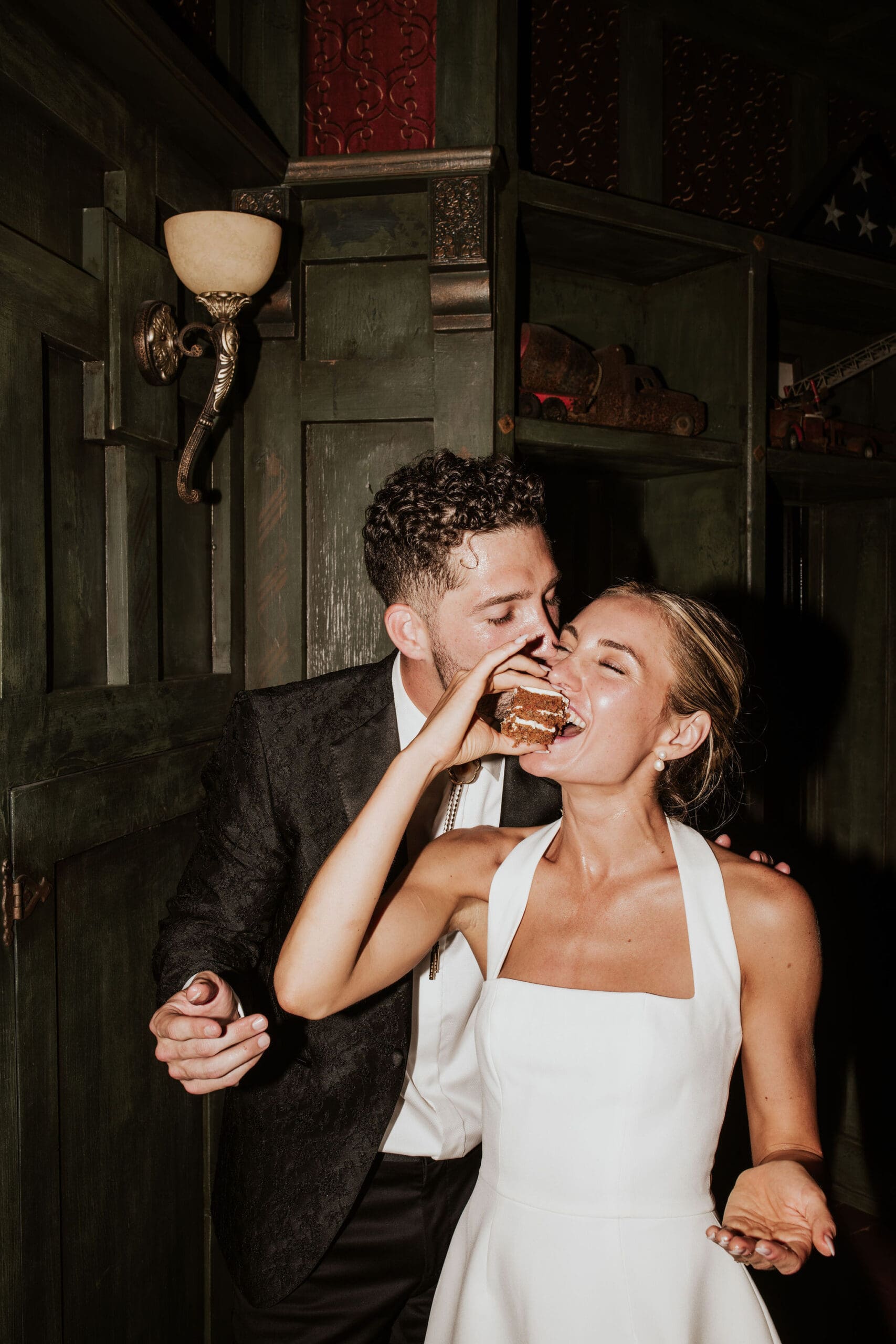 Bride and groom cutting cake with direct flash during Arizona wedding reception dance party
