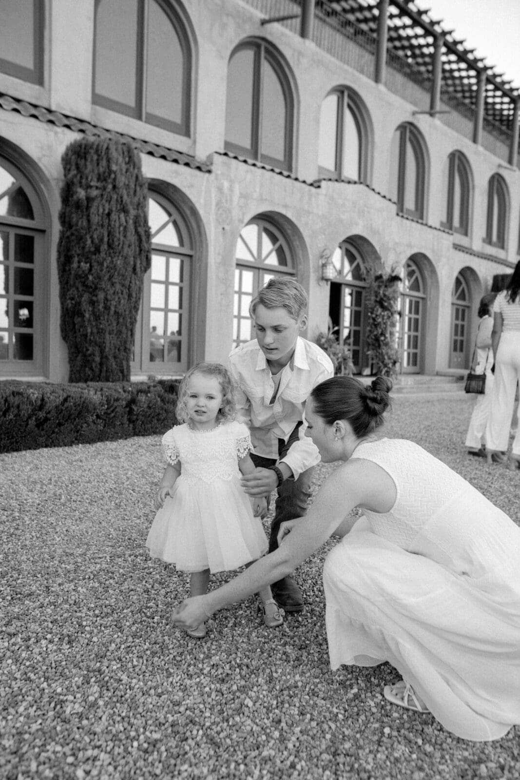 Wedding guests mingling outside historic Jerome Arizona venue with mountain views at sunset