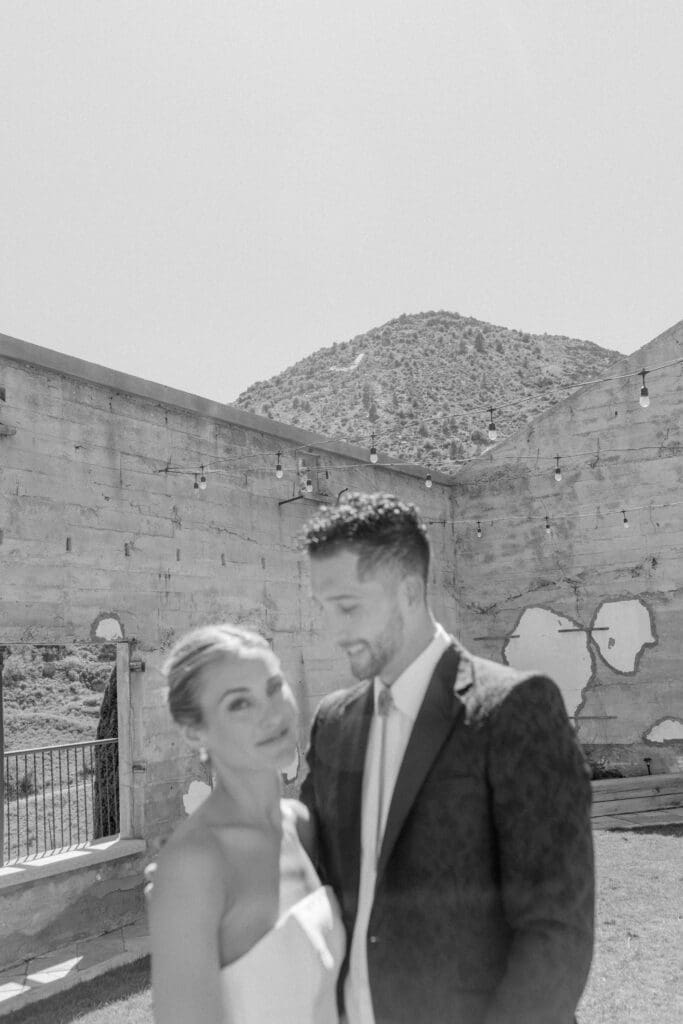 Soft focus bride and groom portrait with desert mountains in the background