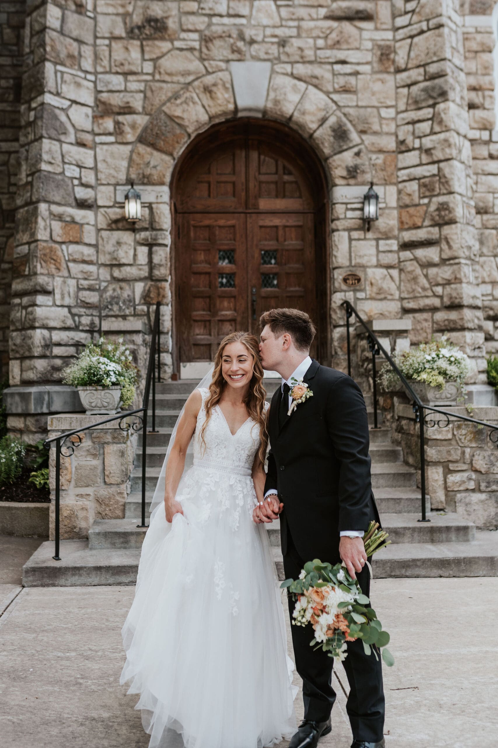 bride and groom portraits outside Holy Trinity after their catholic churches in Kansas City