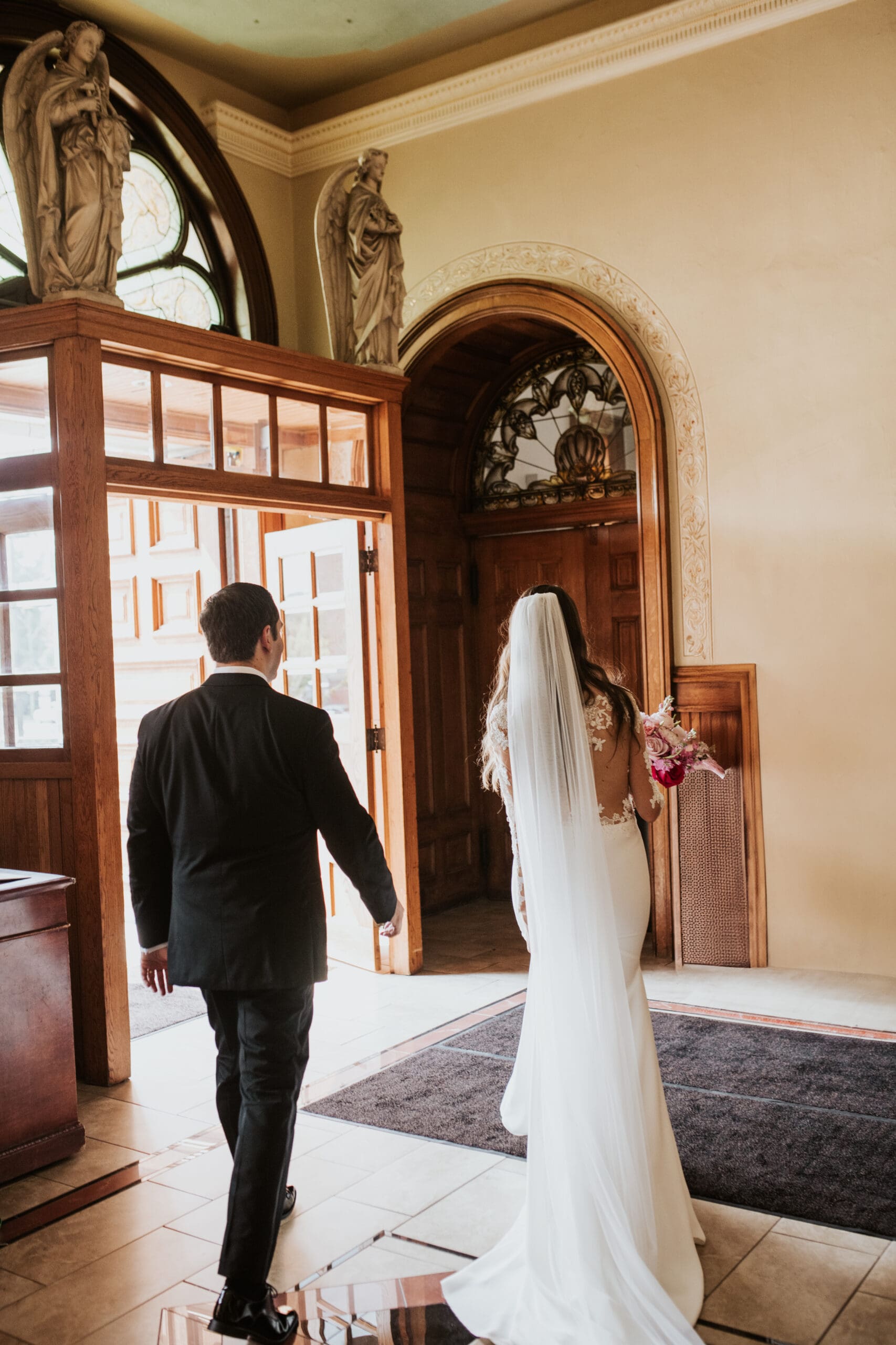 Bride and groom walking in the vestibule of the Church of Saint John Cantius in Chicago after their wedding ceremony