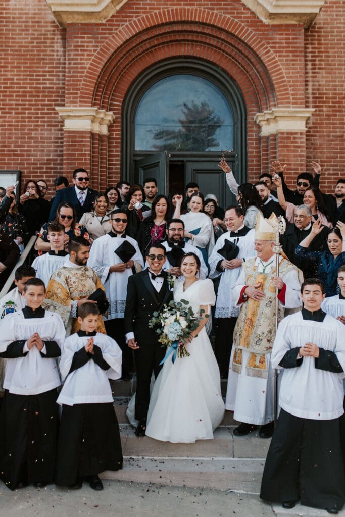 joyful catholic church wedding exit at Old St. Patrick’s Oratory with guests and clergy