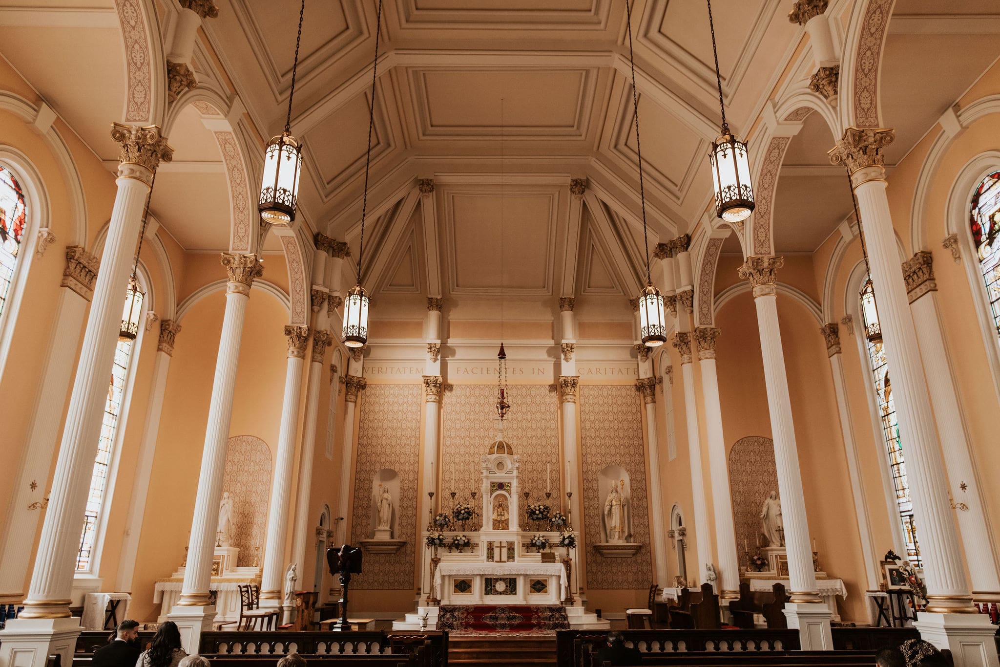 wide ceremony view inside Old St. Patrick’s Oratory during a Catholic wedding Mass this is one of the best catholic churches in Kansas City