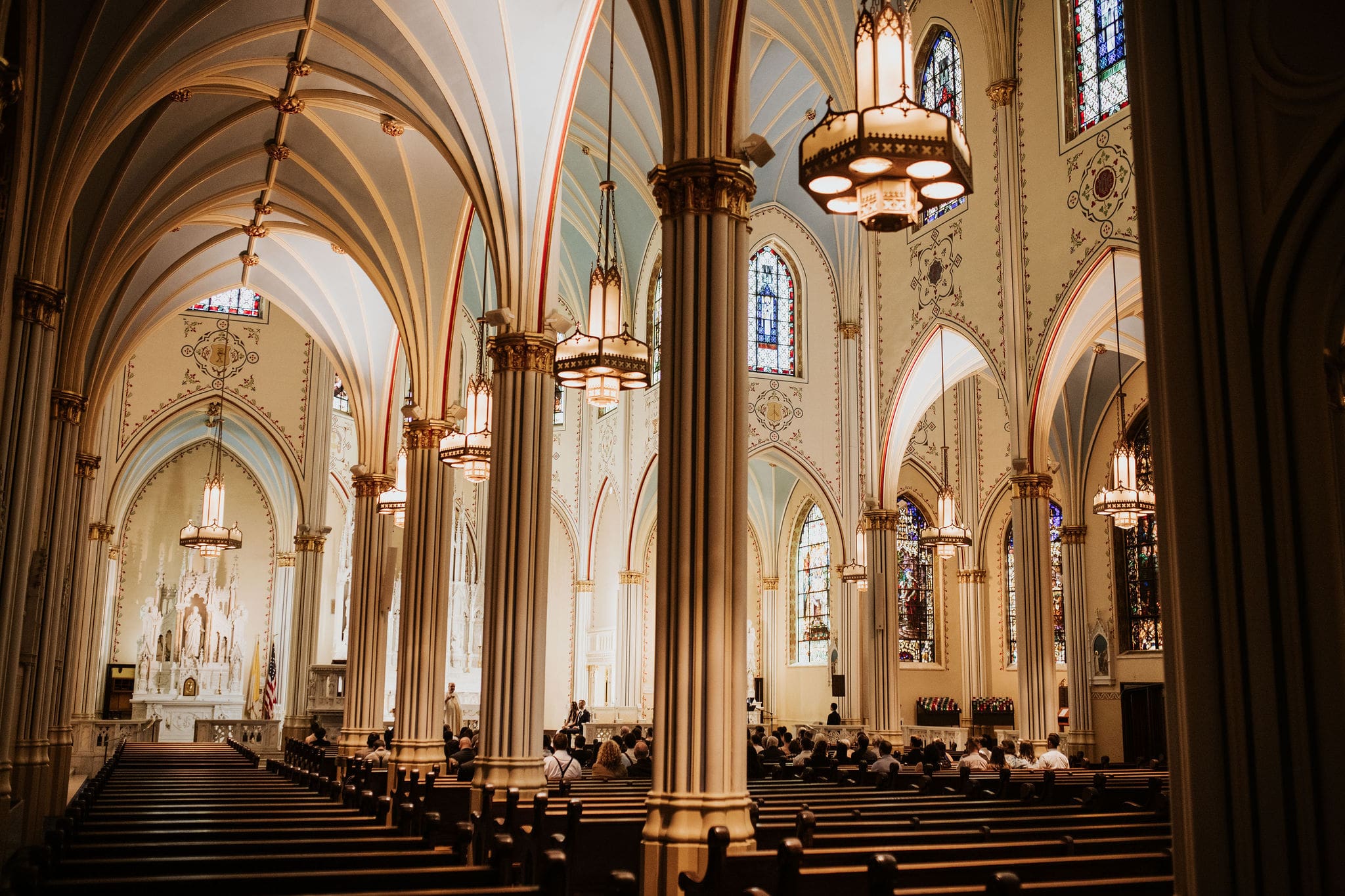 wide ceremony view inside Our Lady of Perpetual Help with art deco church architecture