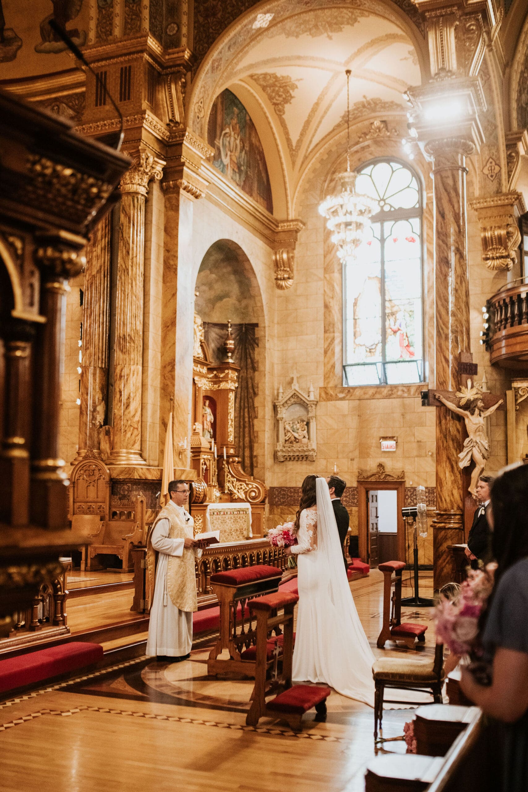 Bride and groom exchanging vows during Catholic wedding Mass at Saint John Cantius Chicago.