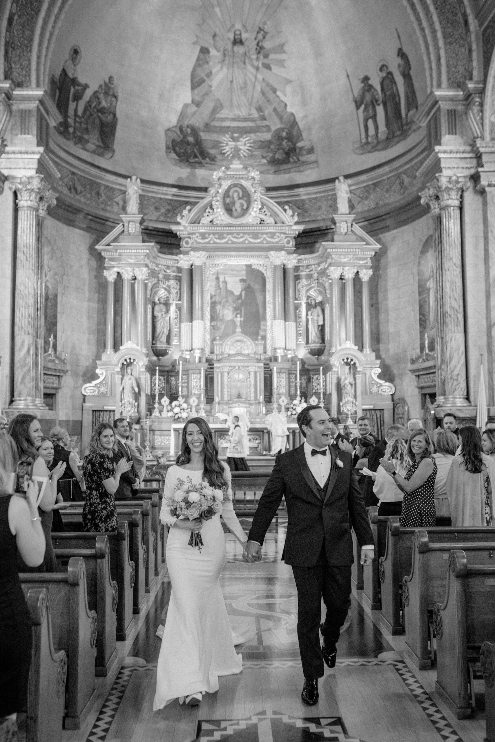 Bride and groom walking down the aisle after their Catholic wedding ceremony at Saint John Cantius Chicago.