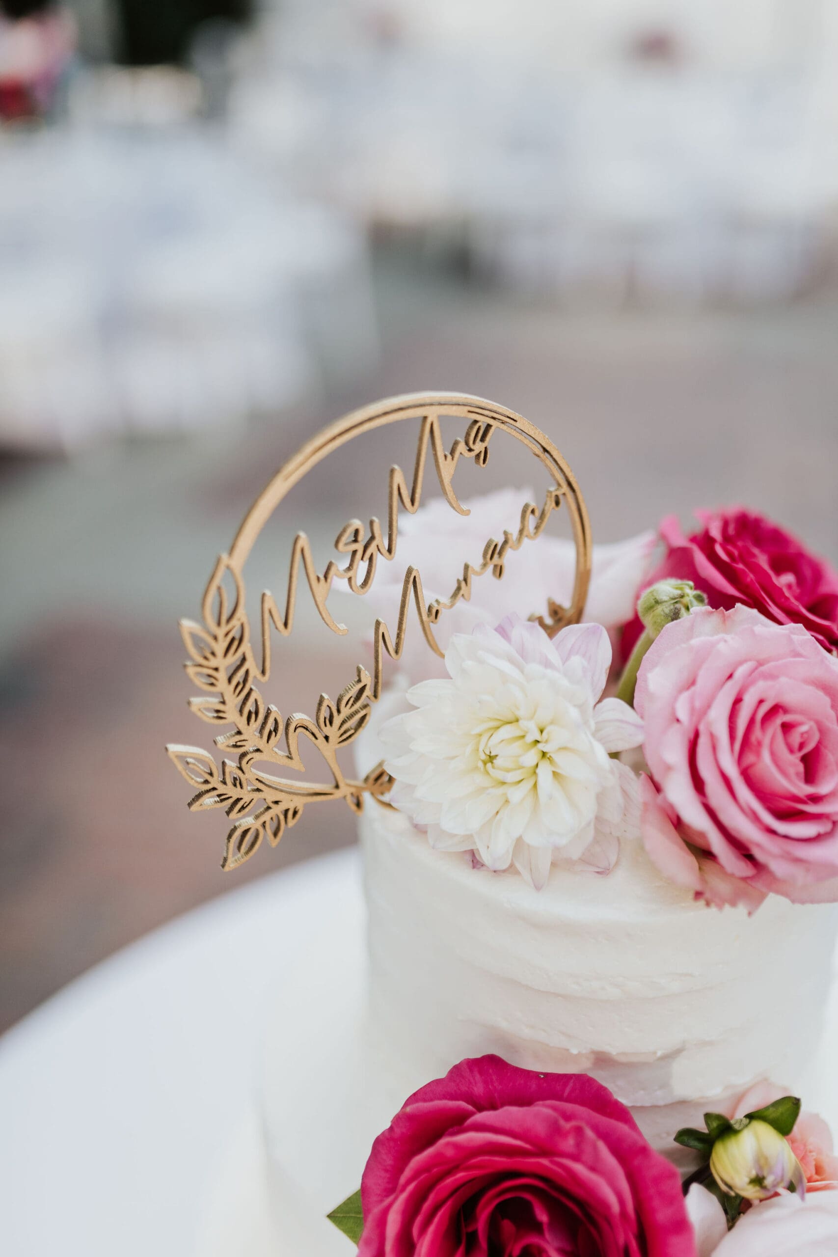 Floral wedding cake with pink roses and custom Mr and Mrs topper.