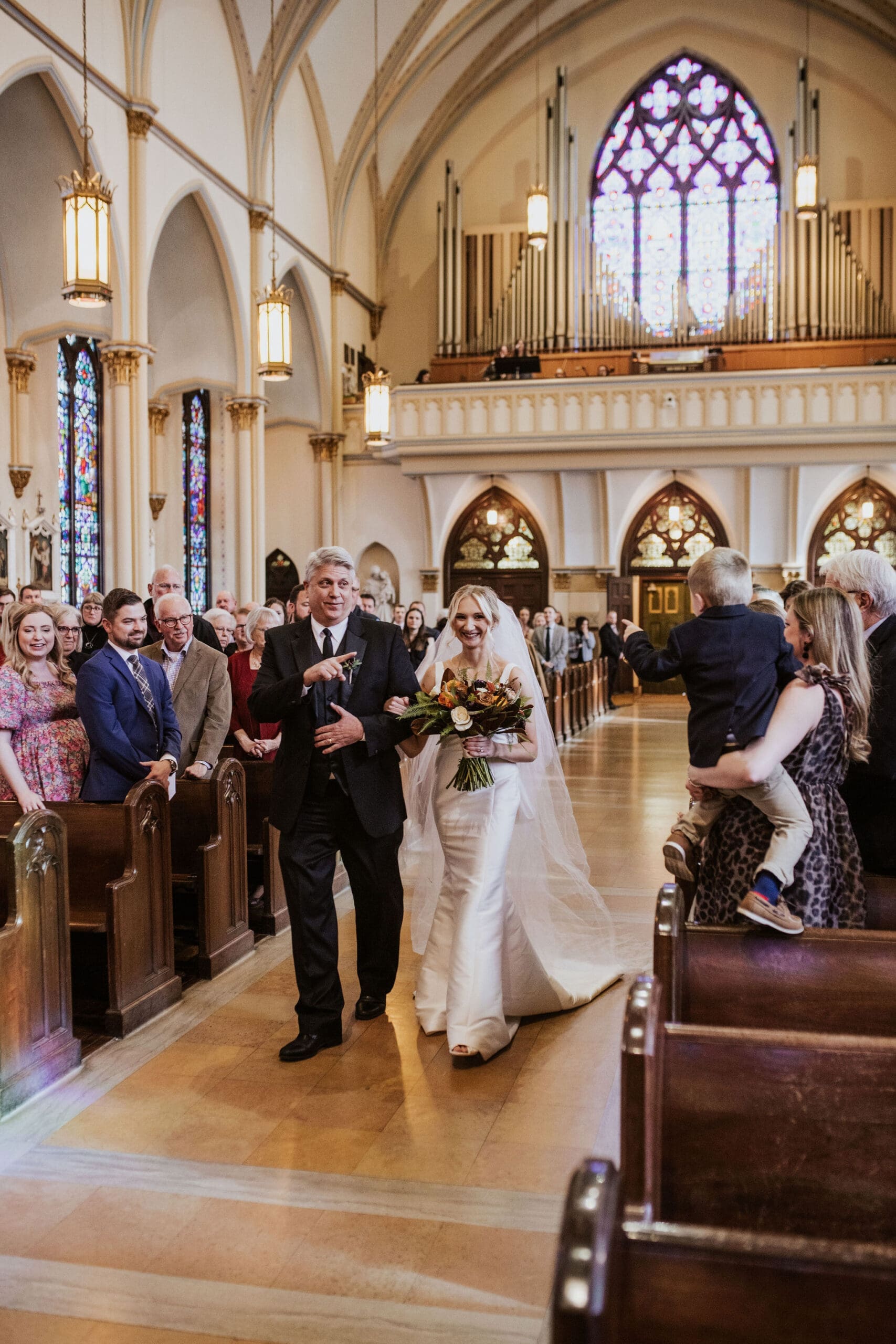 Elegant cathedral ceremony with glowing stained glass windows and classic Catholic wedding traditions