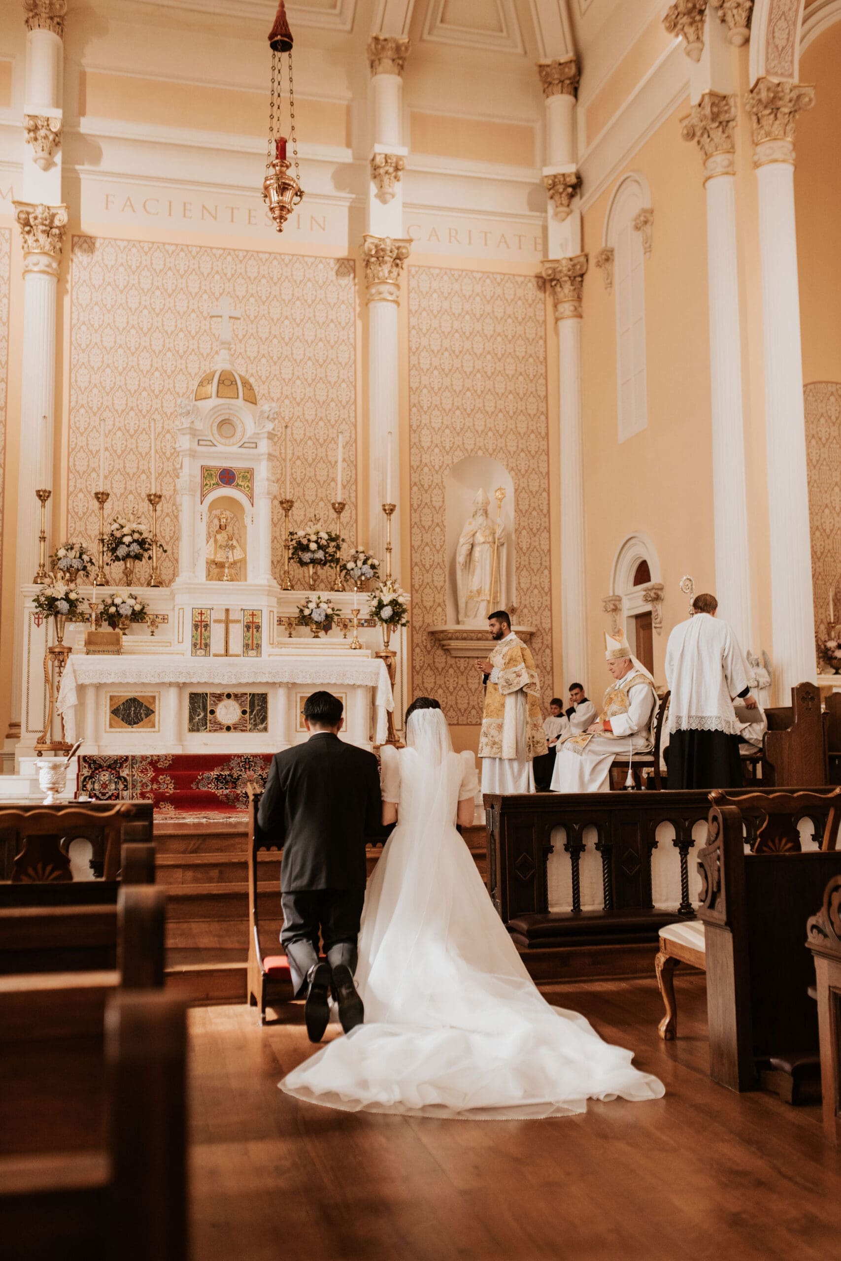Intimate wedding Mass at Old St. Patrick’s Oratory with warm golden light and historic church details