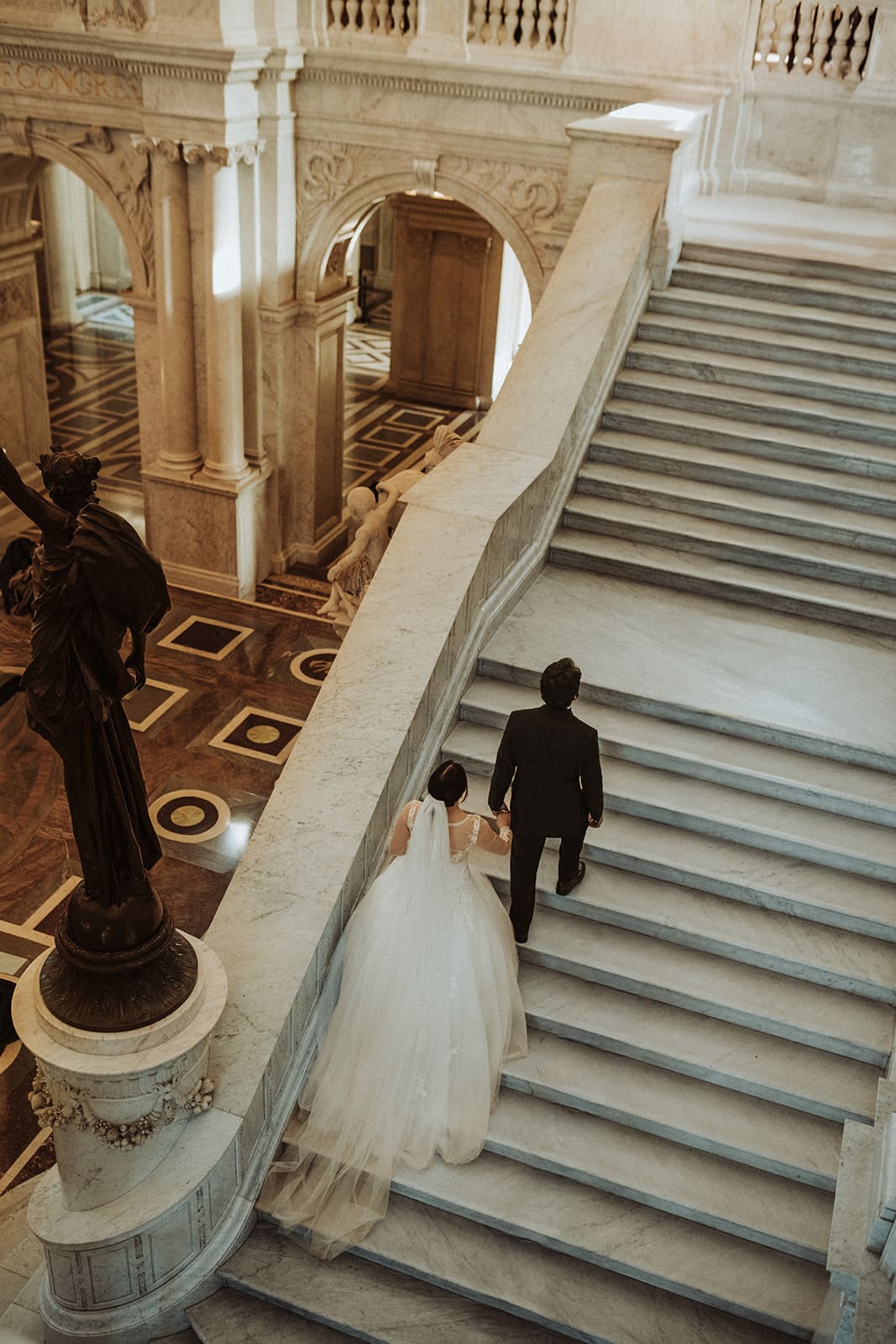 washington dc wedding photos couple walking up library of congress marble staircase