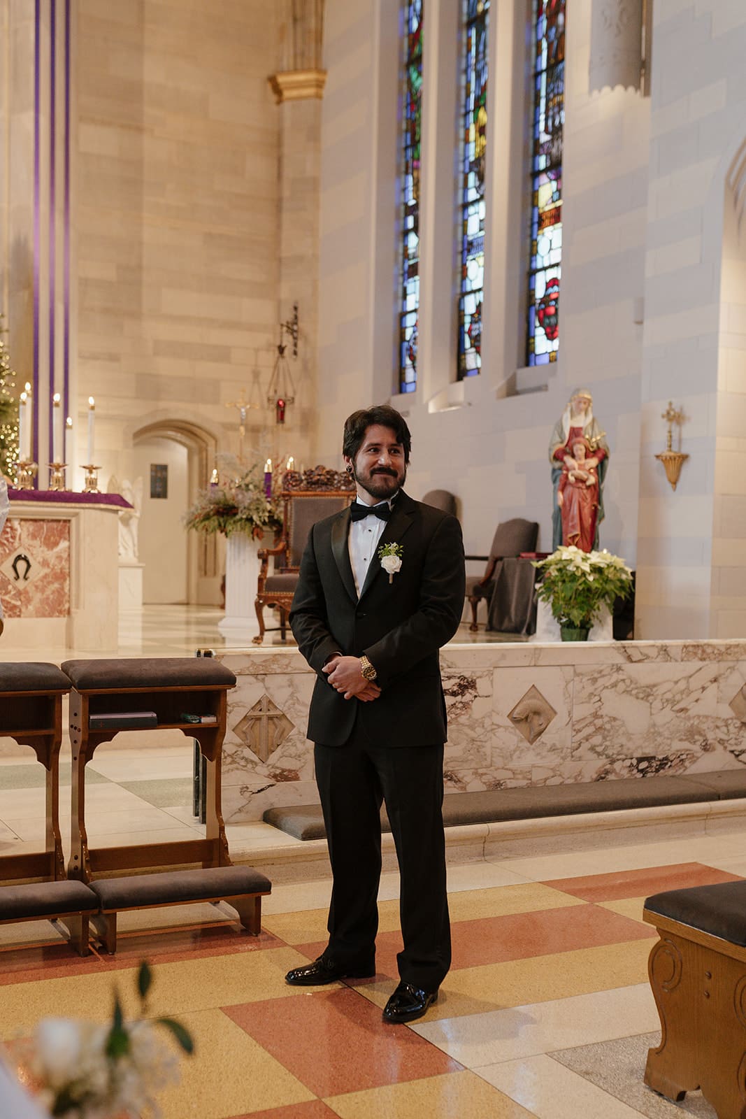A groom waiting at altar at st ann’s catholic church during a wedding ceremony