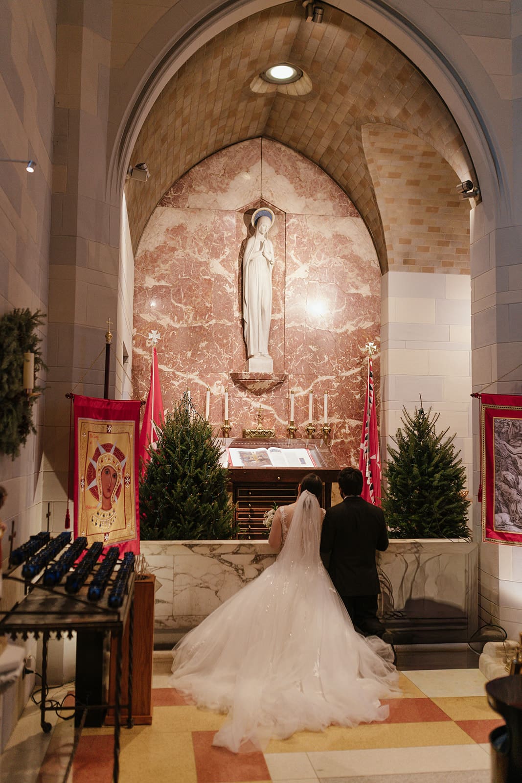 A couple kneeling at the altar at st ann’s catholic church wedding in DC