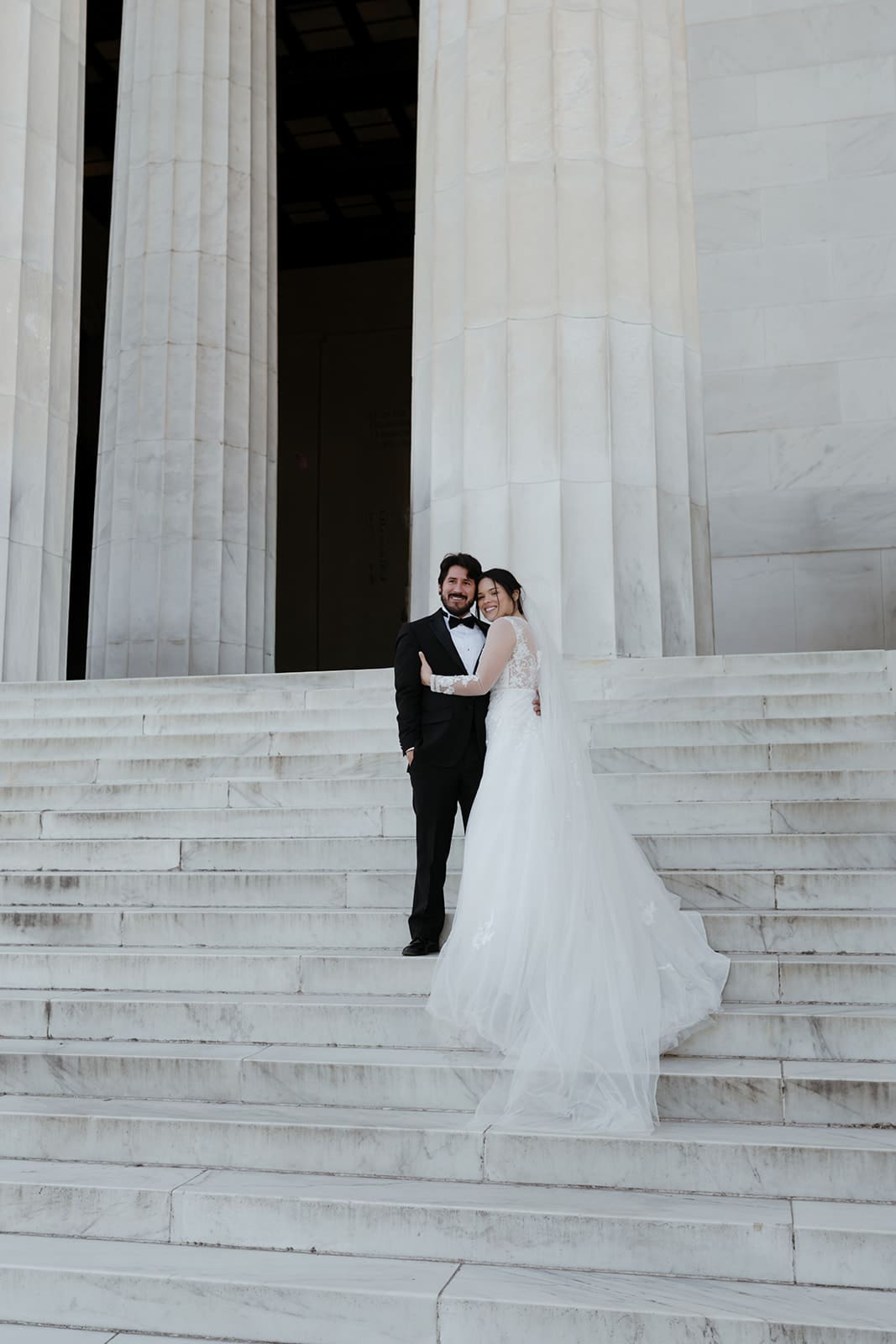 A bride and groom portrait at lincoln memorial columns washington dc