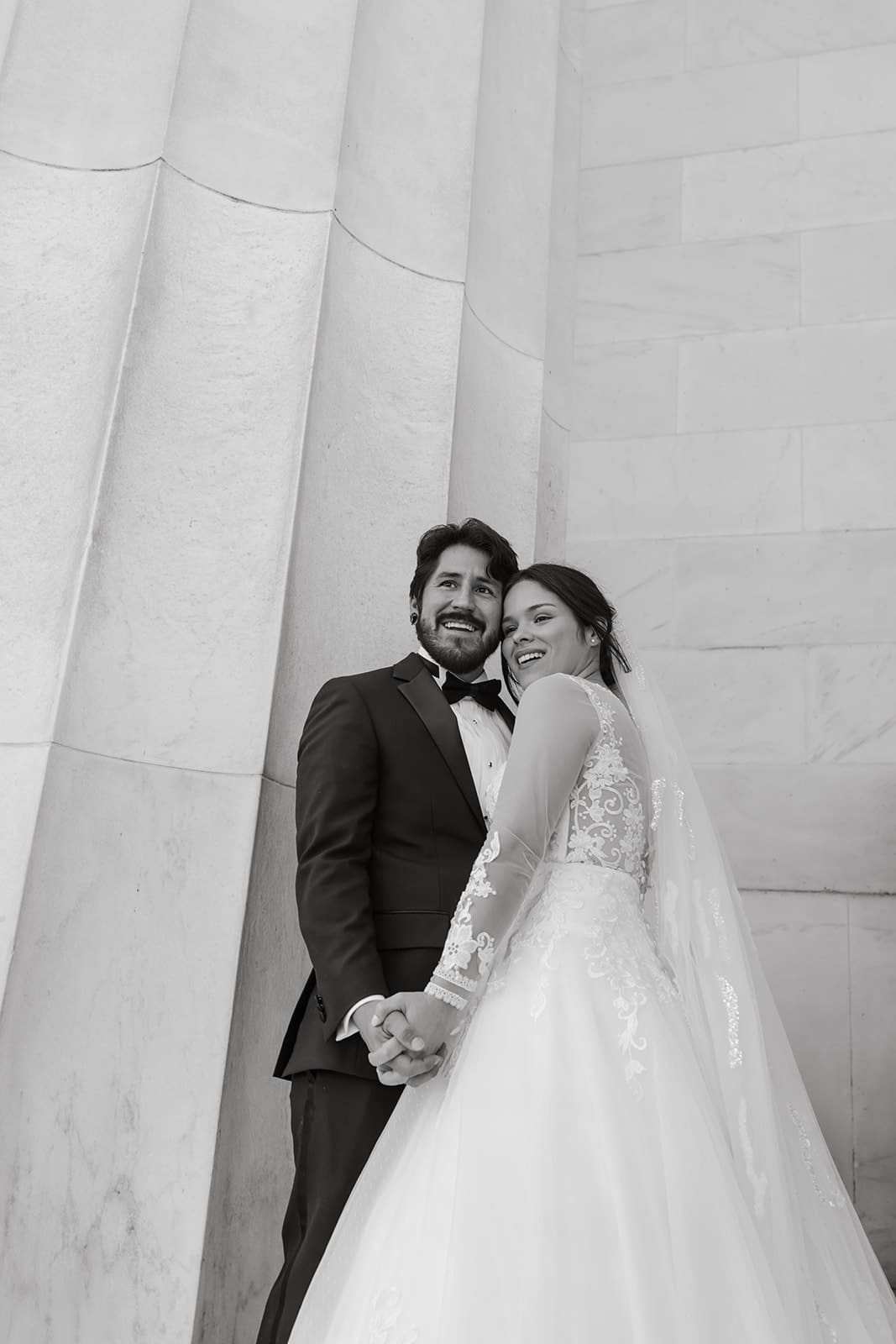washington dc wedding photos couple holding hands on the lincoln memorial stairs