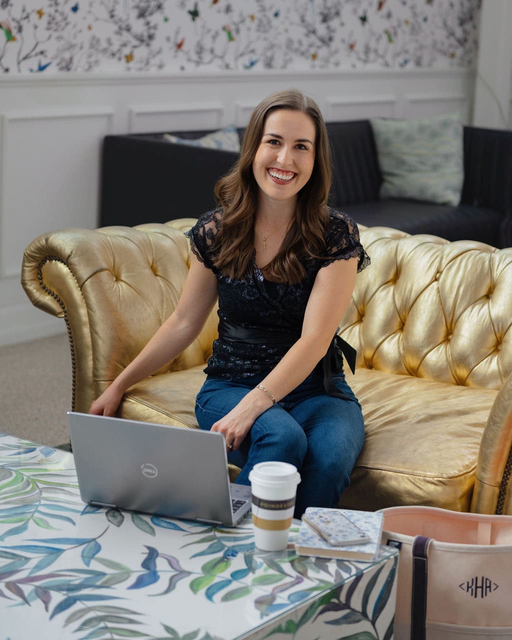 Atlanta wedding planner Kimberly H. of Little Flower Event Co working on wedding coordination details with laptop and coffee in Atlanta office