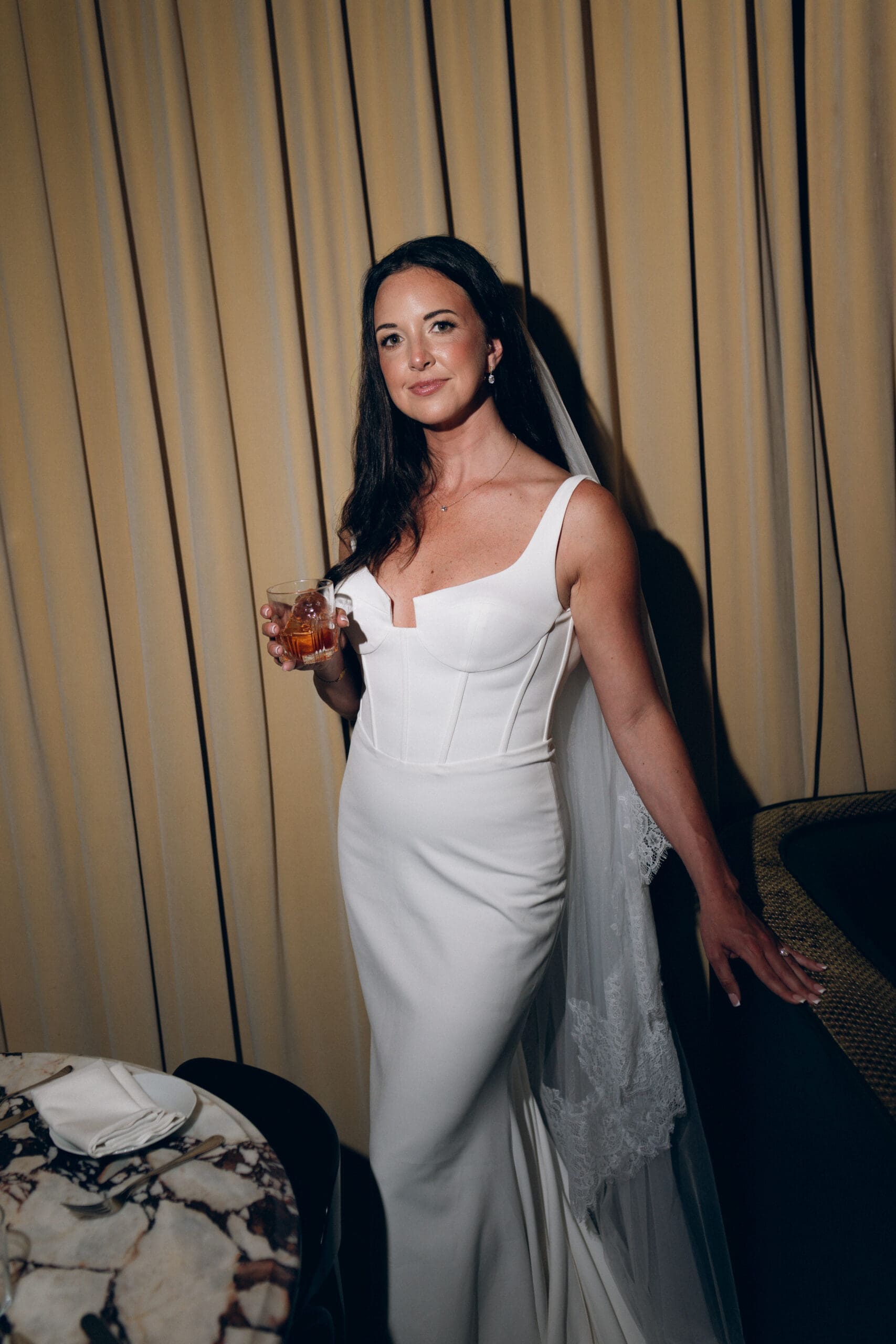 Elegant bride portrait during wedding reception with modern bridal gown and cocktail hour details