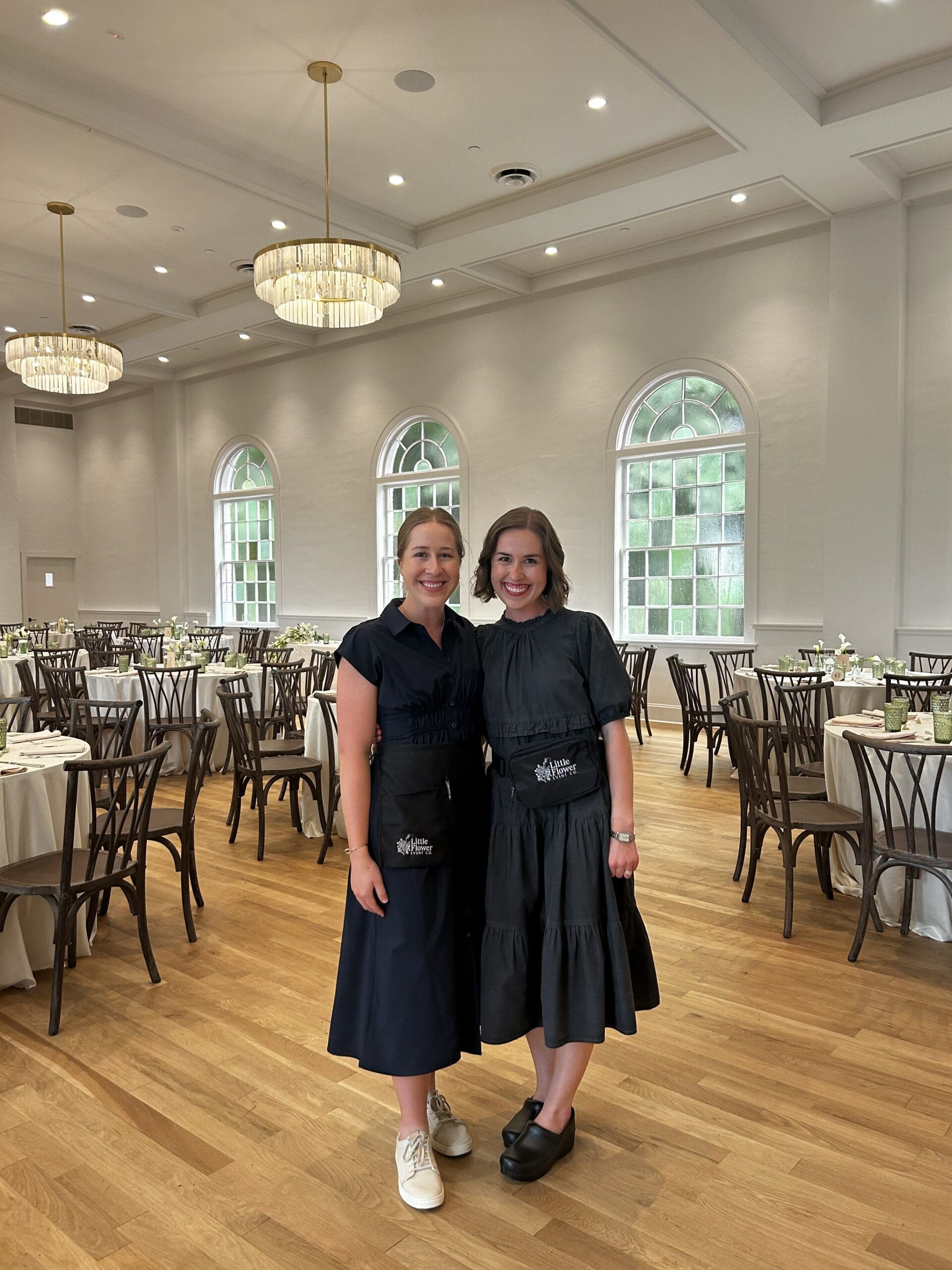 Little Flower Event Co planning team posing inside elegant Atlanta wedding reception venue before guests arrive
