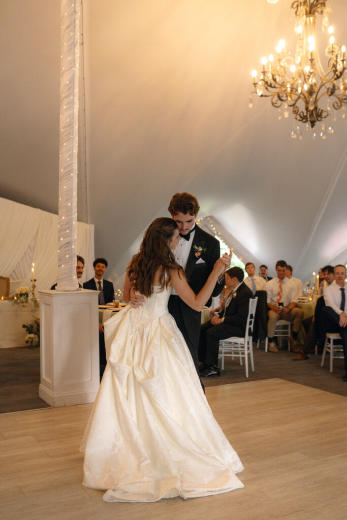 Romantic first dance of the bride in a jacquard ballgown and the groom in a tuxedo under the draped ceiling of the Longview Mansion Pavilion.