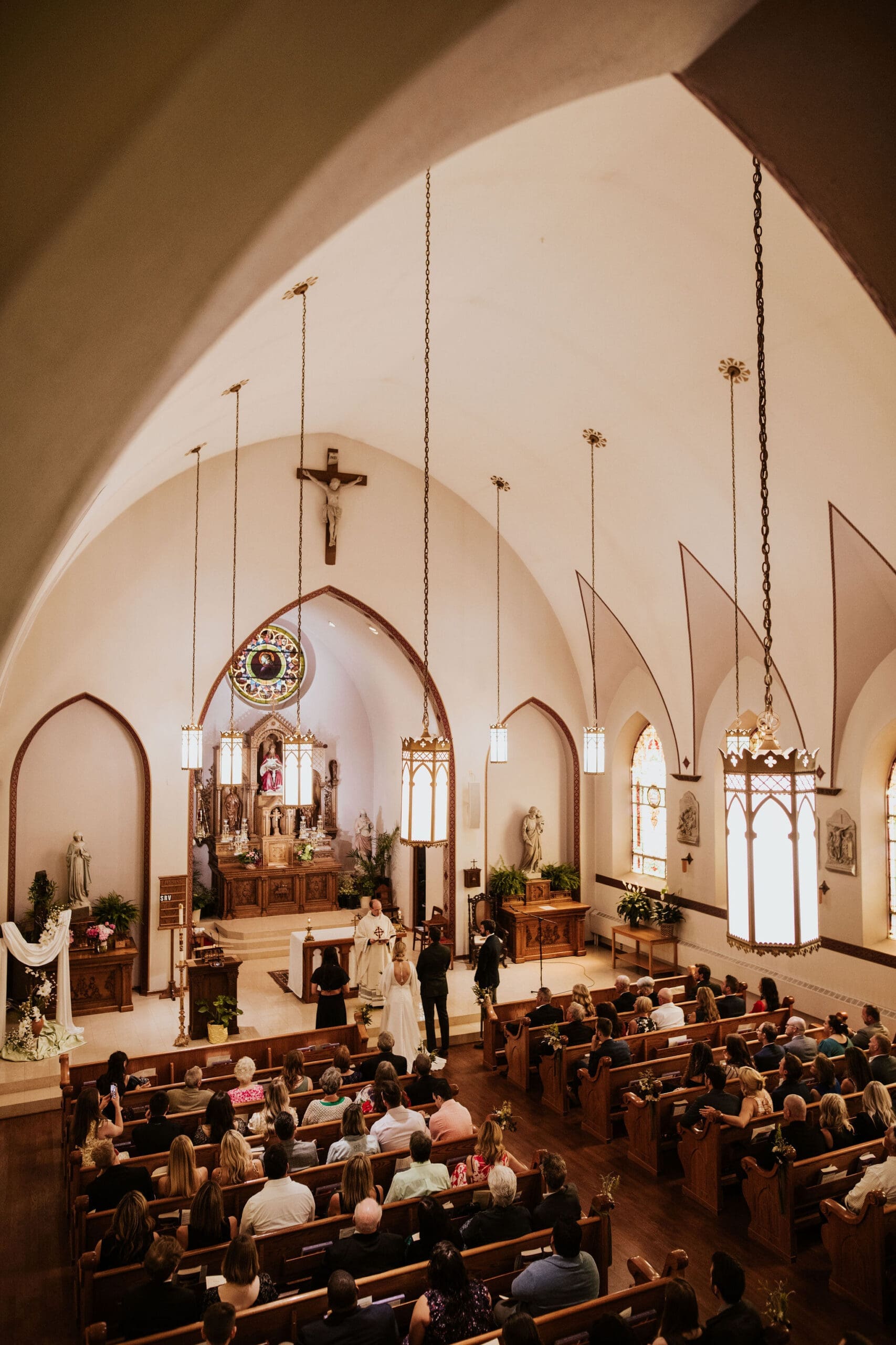 Holy Trinity Catholic Church filled with guests during a wedding ceremony in Weston MO