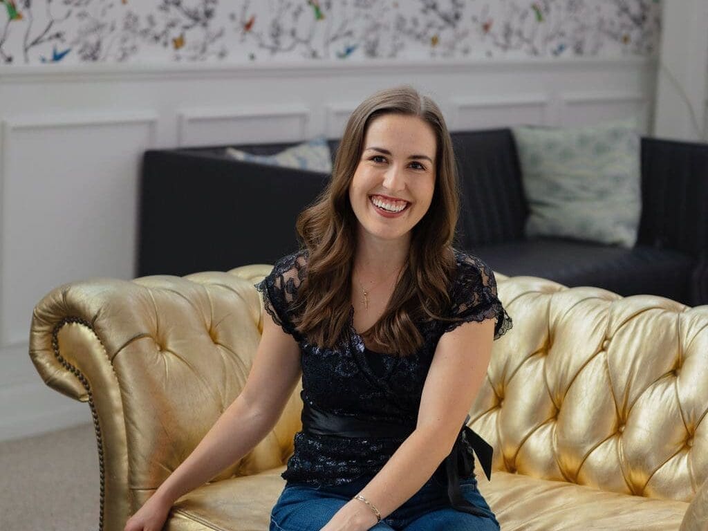 Atlanta wedding planner Kimberly H. of Little Flower Event Co working on wedding coordination details with laptop and coffee in Atlanta office