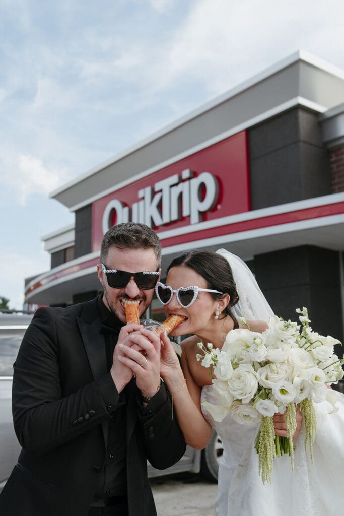 Bride and groom eating snacks outside QuikTrip in heart-shaped sunglasses after their wedding