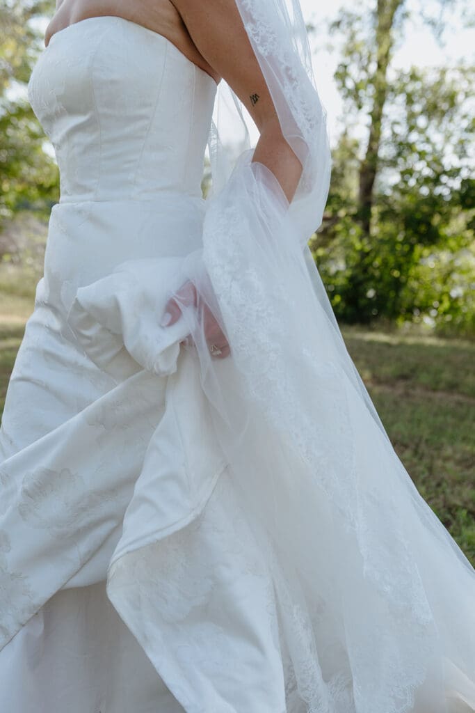 Close-up of bride's wedding dress train and lace veil detail