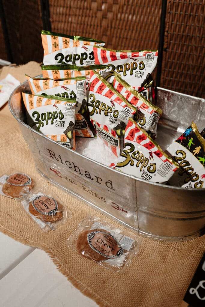 Personalized snack bucket with Zapp's chips and pecan caramels for a Louisiana-inspired wedding reception