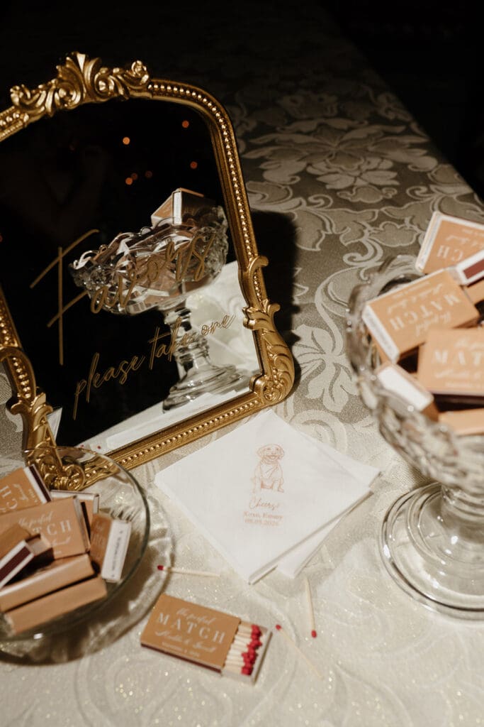 Wedding favors table with personalized matchboxes and cocktail napkins