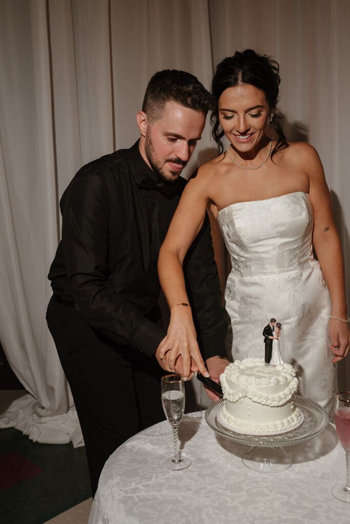 Bride and groom cutting their funfetti wedding cake together