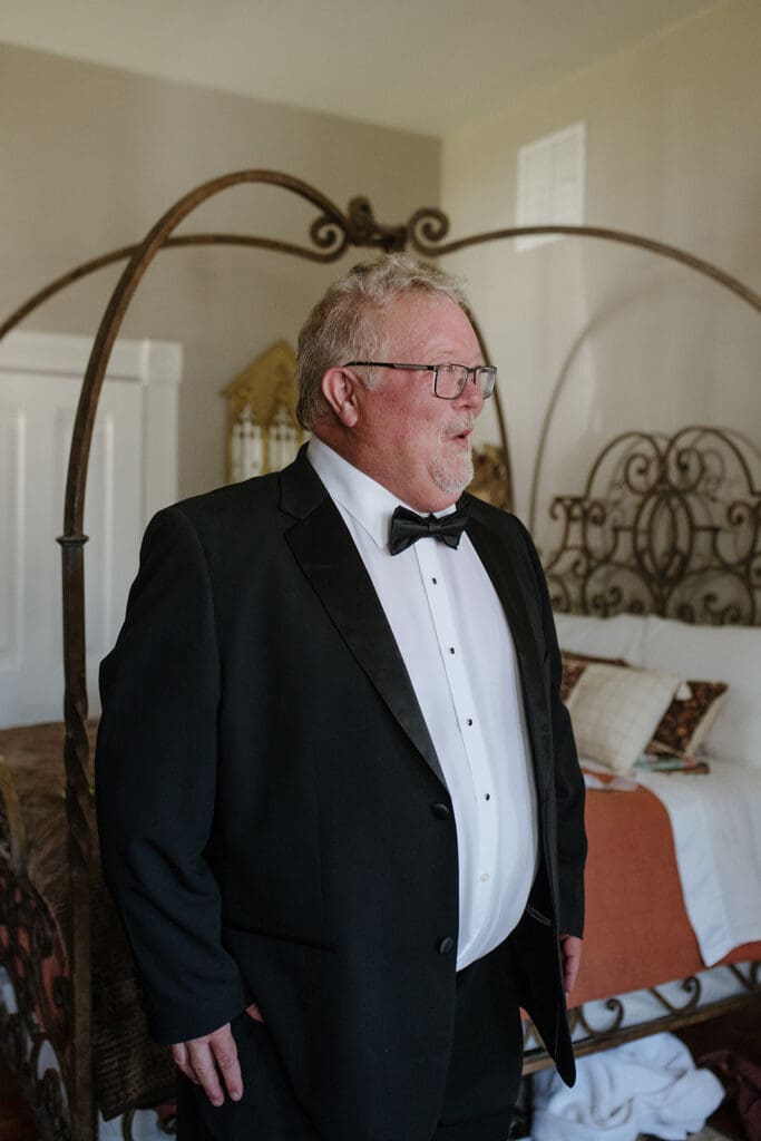 Father of the bride looking amazed at his daughther before the wedding ceremony