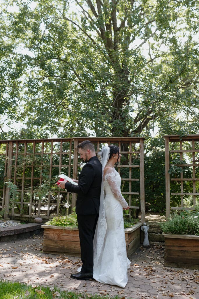 Bride and groom sharing a first touch and prayer before their wedding at Our Lady of Guadalupe Catholic Church